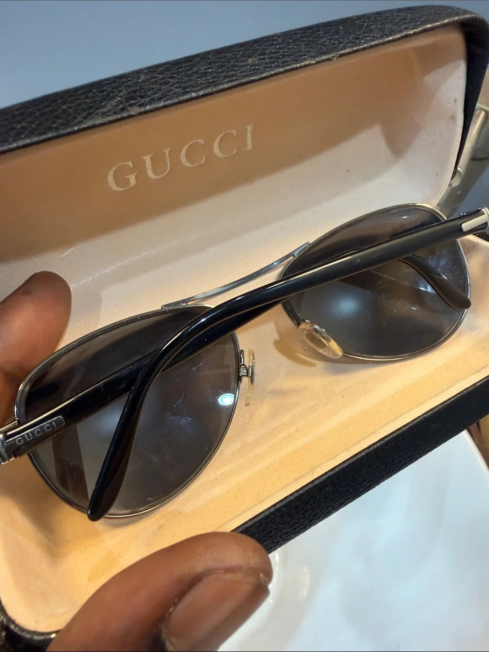 Gucci Men's Black Oval Sunglasses with Silver Accents